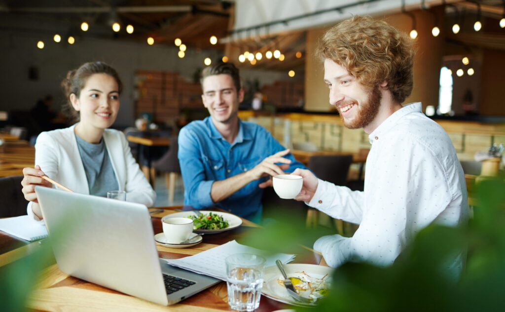 entry level job young worker smiling while working in a team environment