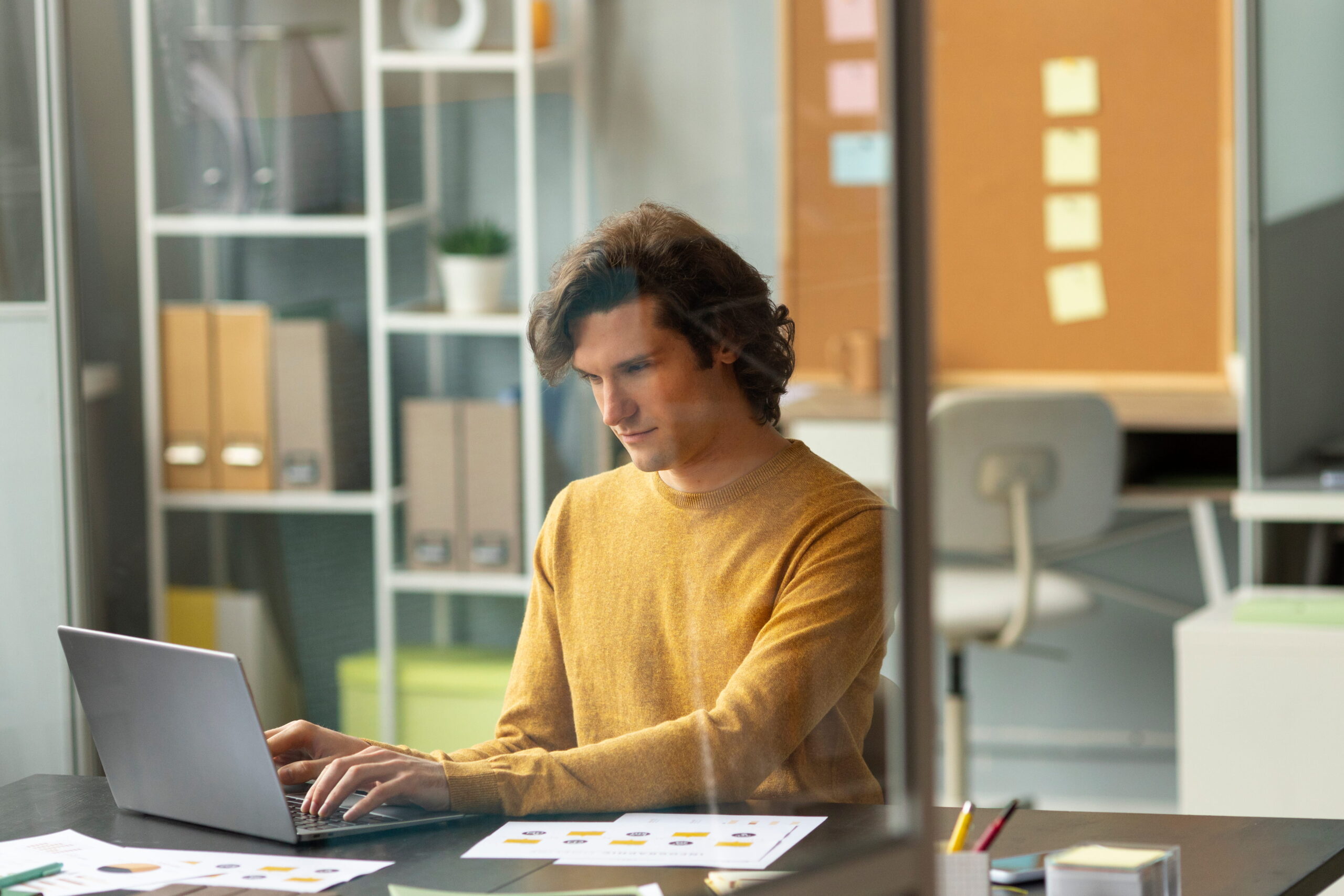 young man writing a warehouse resume on laptop with no work experience