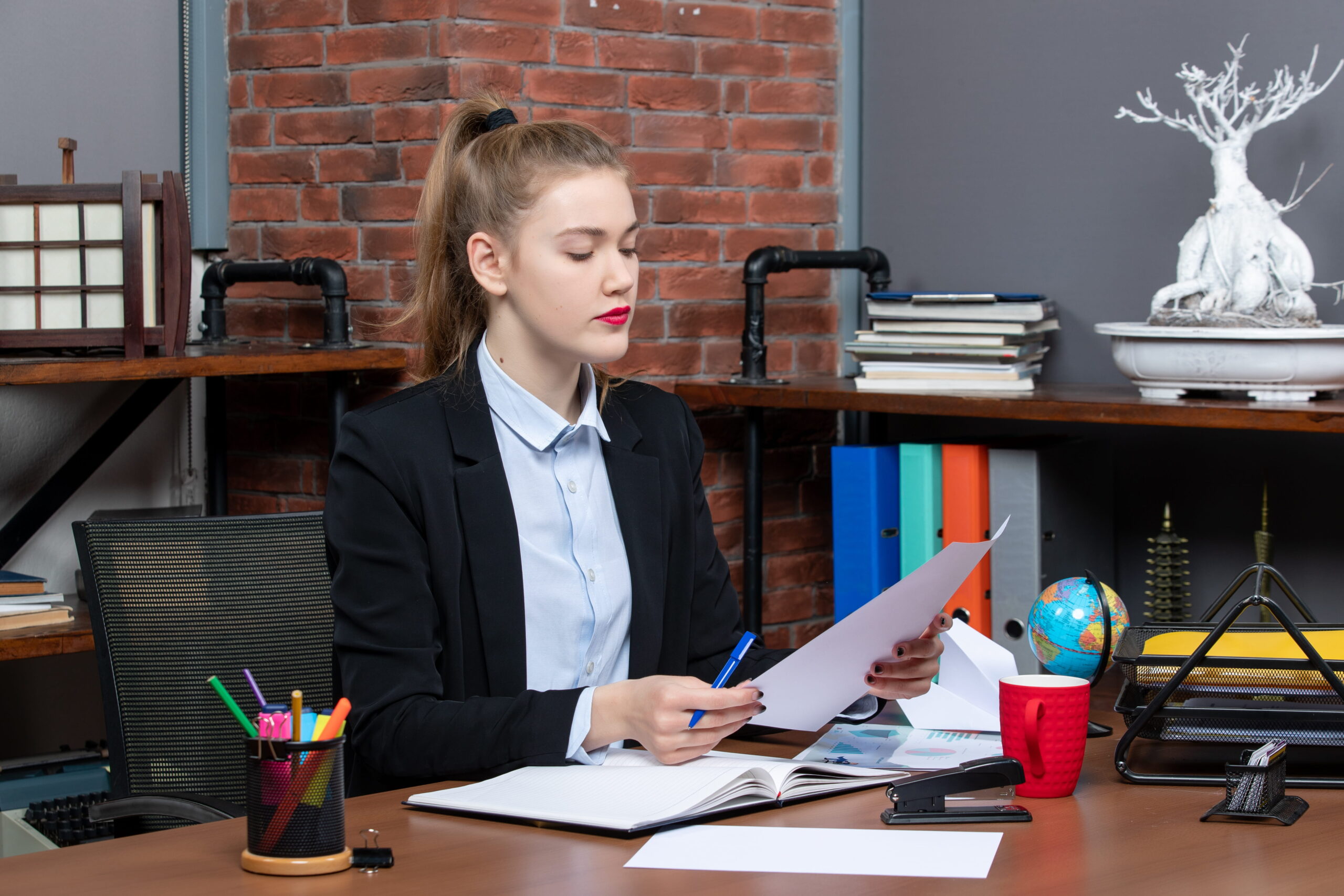 Senior manager reviewing M&A documents at a corporate office desk in the USA