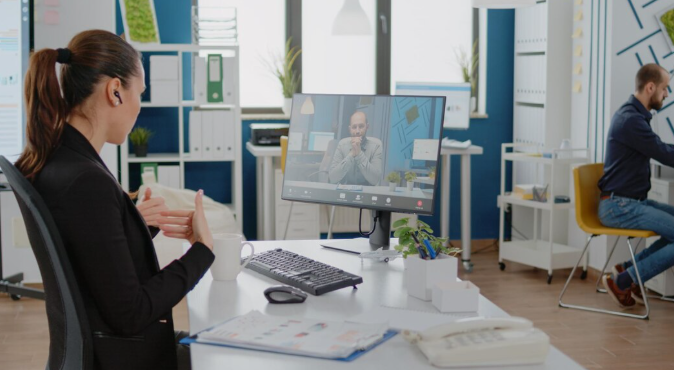 Customer Success Manager conducting remote business review call with corporate client 2026
