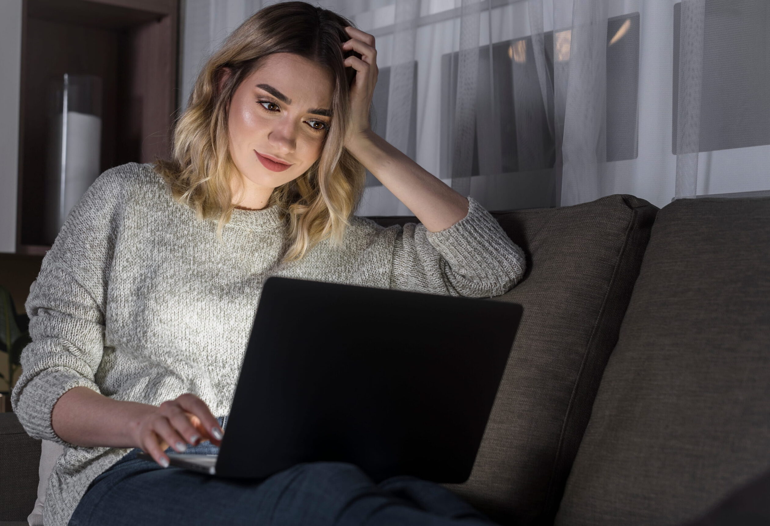 A frustrated job seeker staring at laptop screen with no job offer emails in 2026