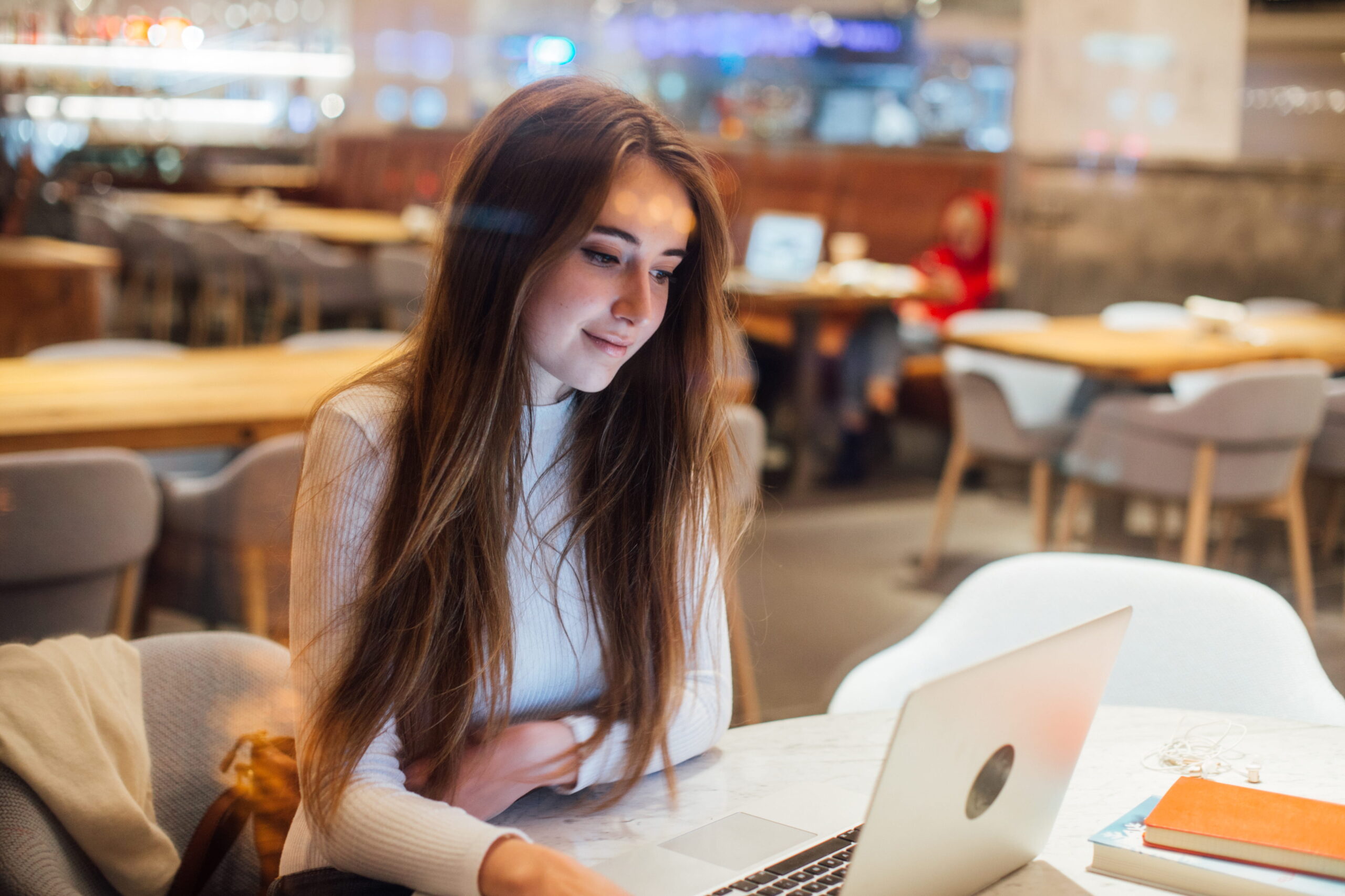International student working an on-campus job at a university library help desk