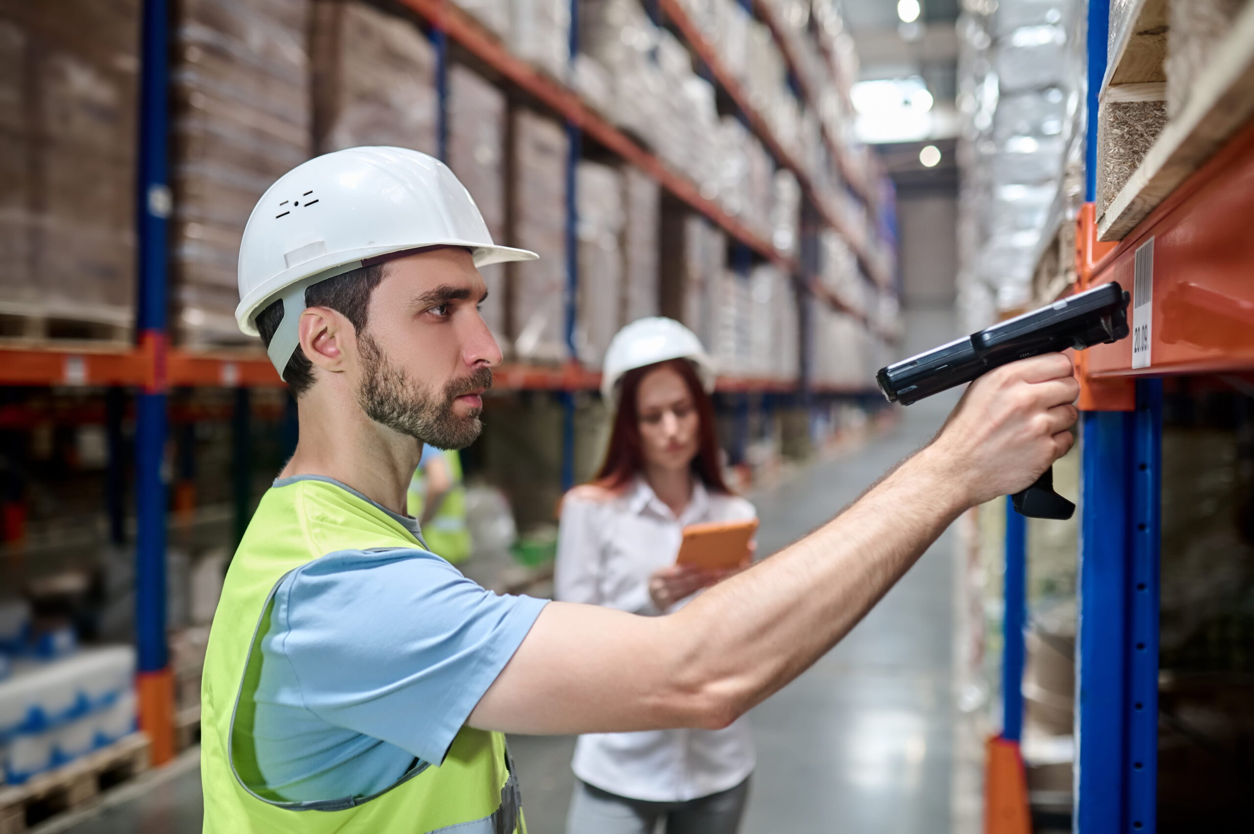 Amazon warehouse worker scanning packages during the Amazon warehouse hiring process in 2026 with salary and job application information.