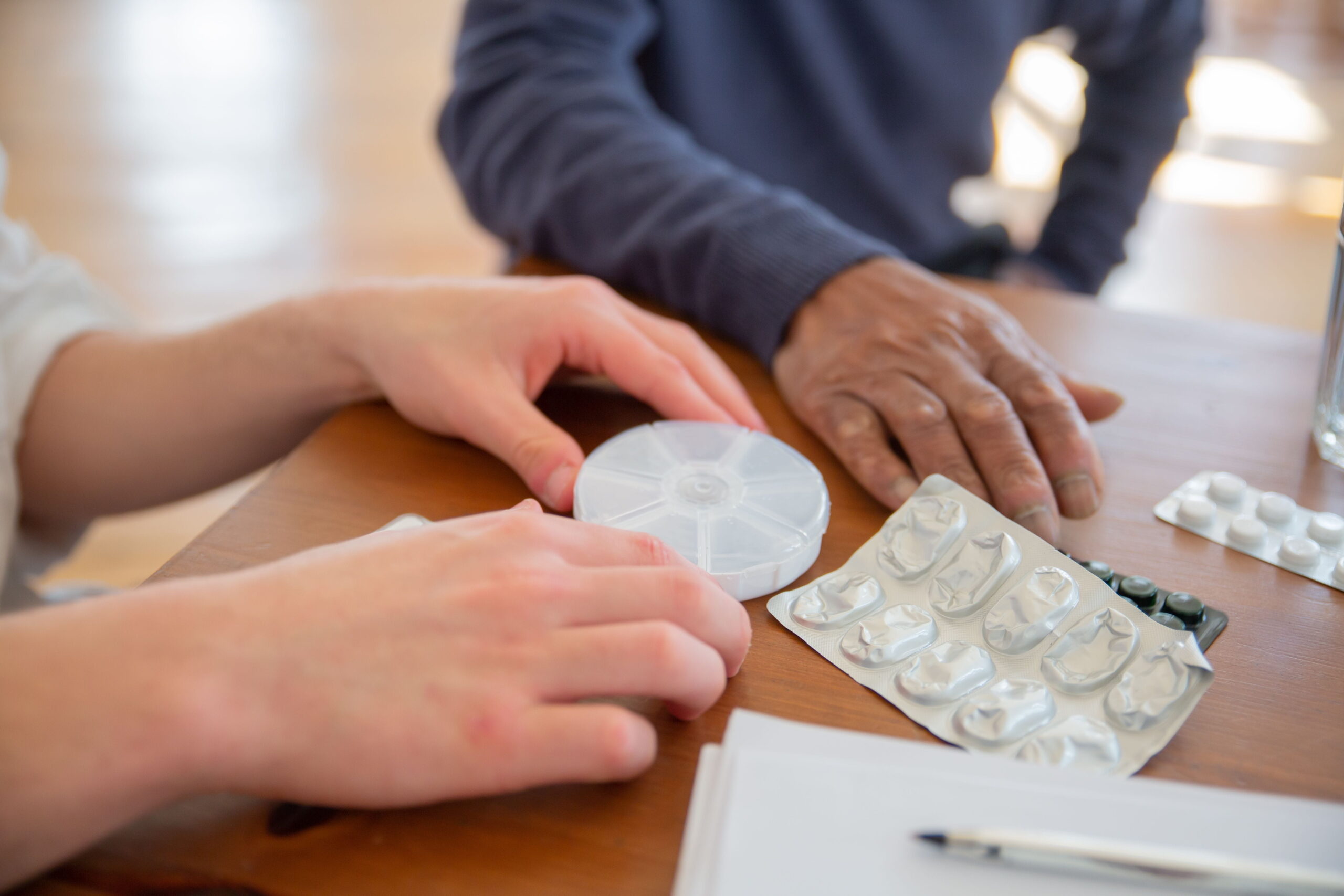 health aide checking medication schedule with client